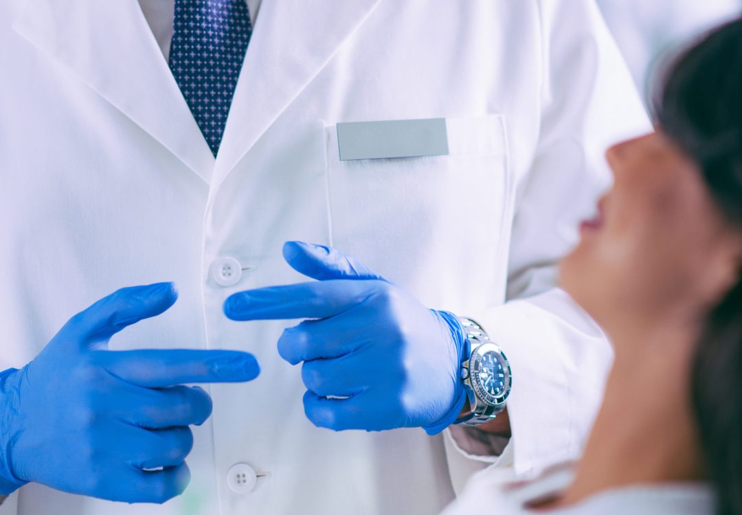 Young Dentist Talking to Satisfied Patient